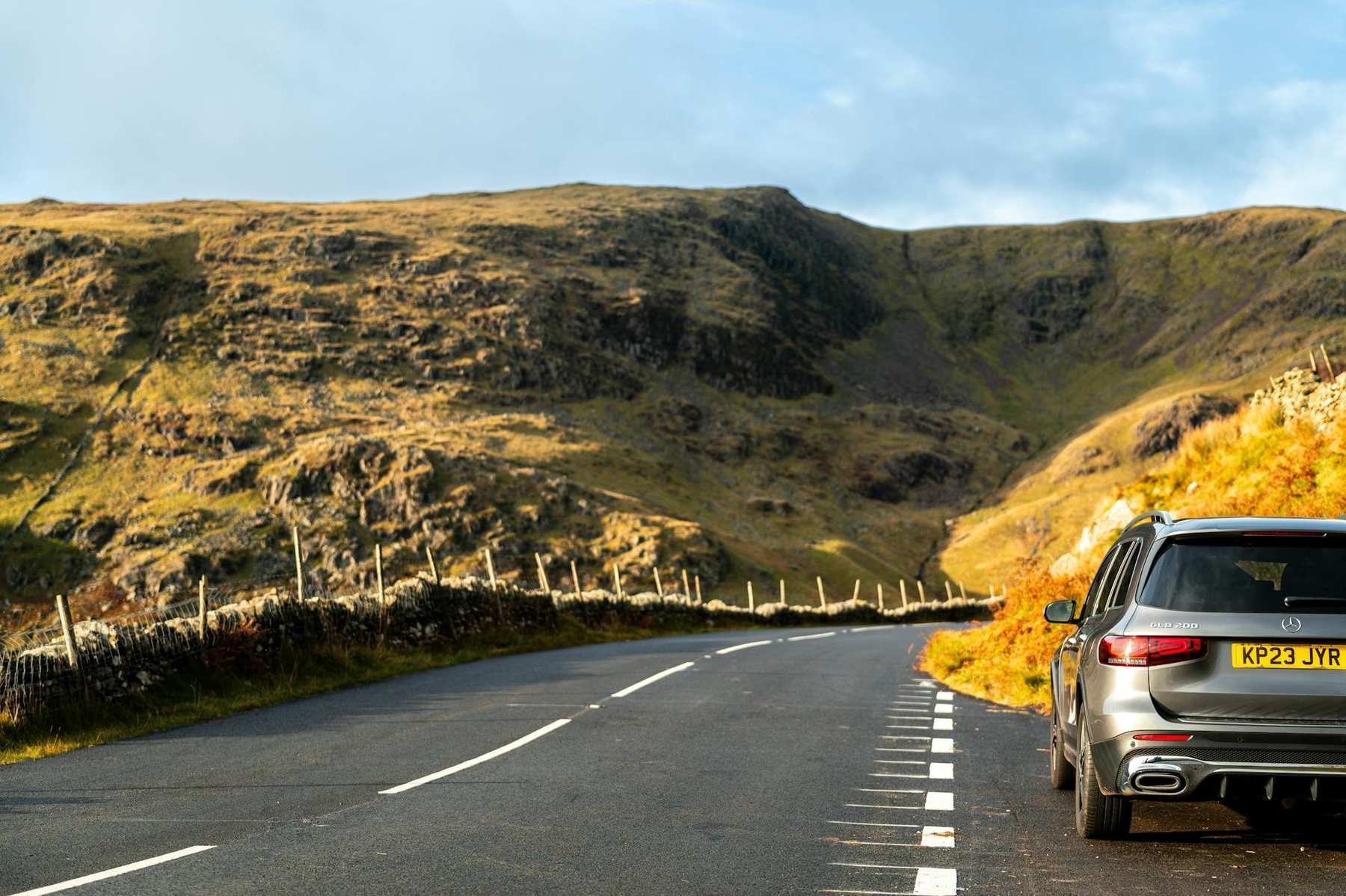Rental car driving on a scenic New Zealand road on an Auckland road trip