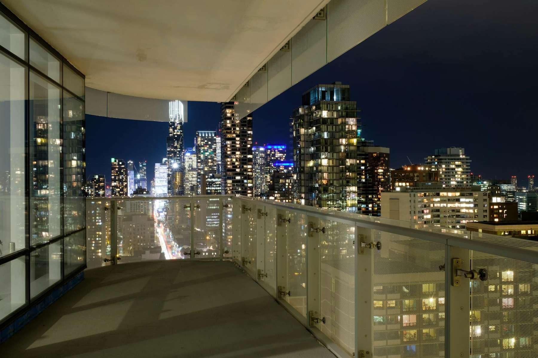 Auckland city skyline at night from a high-rise vacation rental apartment balcony